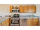 Updated kitchen featuring granite countertops, stainless steel appliances, and light-colored cabinetry at 7474 E Arkansas Ave # 13-02, Denver, CO 80231