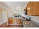 This kitchen features granite countertops and a view to the living room with a fireplace at 7474 E Arkansas Ave # 13-02, Denver, CO 80231