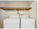 Laundry room with full size washer and dryer, plus shelving at 7474 E Arkansas Ave # 13-02, Denver, CO 80231