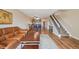 Open-concept living area with hardwood floors flowing into kitchen and stairway access at 7474 E Arkansas Ave # 13-02, Denver, CO 80231