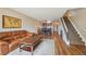 Spacious living room with hardwood floors and view of the kitchen and stairway at 7474 E Arkansas Ave # 13-02, Denver, CO 80231