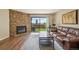 Inviting living room with stone fireplace, wood floors, and large sliding doors to the outside at 7474 E Arkansas Ave # 13-02, Denver, CO 80231