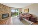 Bright living room featuring a stone fireplace and sliding doors to the outside at 7474 E Arkansas Ave # 13-02, Denver, CO 80231