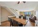 Living space featuring hardwood floors, a stone fireplace, and an adjacent dining area at 7474 E Arkansas Ave # 13-02, Denver, CO 80231