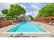 Outdoor pool with lounge chairs, a pergola, and a building with large windows for residents to enjoy summer days at 7474 E Arkansas Ave # 13-02, Denver, CO 80231