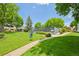 Scenic view of a community tennis court surrounded by lush greenery at 7474 E Arkansas Ave # 13-02, Denver, CO 80231
