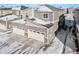 Aerial view of home with snow covered roofs, a two car garage and a driveway at 23527 E 5Th Pl, Aurora, CO 80018