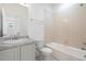 Bright bathroom featuring a vanity with granite countertop, white tile, and a shower-tub combination at 23527 E 5Th Pl, Aurora, CO 80018