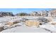 Community outdoor seating area with picnic tables and natural stone features covered in snow at 23527 E 5Th Pl, Aurora, CO 80018