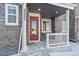 Front entrance with red door, stone facade, and small porch at 23527 E 5Th Pl, Aurora, CO 80018