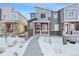 Charming townhouse featuring stone accents, modern siding, and a welcoming red front door at 23527 E 5Th Pl, Aurora, CO 80018