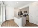 Open kitchen featuring stainless appliances, a center island, and sliding door access to the outside at 23527 E 5Th Pl, Aurora, CO 80018