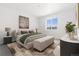 Staged main bedroom features a large window, neutral color palette, and modern furnishings at 23527 E 5Th Pl, Aurora, CO 80018