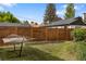 Grassy backyard with a hammock and a wood fence for privacy at 4567 Grove St, Denver, CO 80211