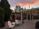 Relaxing backyard patio featuring a barrel sauna, stylish seating, and festive string lights at 4567 Grove St, Denver, CO 80211