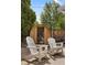 Relaxing backyard retreat with chairs and a wooden barrel sauna at 4567 Grove St, Denver, CO 80211