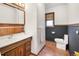 Cozy bathroom with charming wood accents, tile floor, and vintage-inspired mirror at 4567 Grove St, Denver, CO 80211