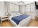 Bright bedroom with shuttered windows, light hardwood floors, and a ceiling fan at 4567 Grove St, Denver, CO 80211