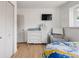 Well-lit Bedroom displays changing table and dresser along with a comfortable lounging chair at 4567 Grove St, Denver, CO 80211