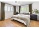 Serene bedroom featuring hardwood floors, a comfortable bed, and natural light at 4567 Grove St, Denver, CO 80211