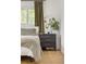 Bright bedroom displays stylish nightstand, modern lamp, and light green decor at 4567 Grove St, Denver, CO 80211