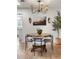 Bright dining area featuring a stylish light fixture, artwork, and views to kitchen at 4567 Grove St, Denver, CO 80211