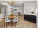 Elegant dining area with modern lighting and furniture, seamlessly flowing into a spacious living room at 4567 Grove St, Denver, CO 80211