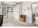 Bright entryway with white brick, modern light fixture, and a unique accent chair at 4567 Grove St, Denver, CO 80211
