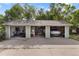 Spacious three-car garage with modern equipment and a parked Rivian at 4567 Grove St, Denver, CO 80211