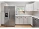 Well-lit kitchen featuring modern appliances, white cabinets, and ample counter space at 4567 Grove St, Denver, CO 80211