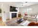 Relaxing living room with a fireplace, plush seating, and a stylish rug at 4567 Grove St, Denver, CO 80211