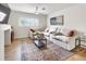 Inviting living room features a plush sectional sofa, decorative rug, and ample natural light at 4567 Grove St, Denver, CO 80211