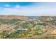 A panoramic aerial view of a city nestled between two mesas, featuring sports fields and greenery at 919 Russell St, Golden, CO 80401