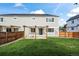 A well-maintained backyard featuring a wooden pergola, seating, and lush lawn at 919 Russell St, Golden, CO 80401