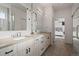 Modern bathroom with double vanity, sleek fixtures, and an open doorway to a bedroom at 919 Russell St, Golden, CO 80401