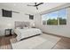 Spacious bedroom with large window, fan, and stylish barn door accents at 919 Russell St, Golden, CO 80401