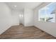 A bright bedroom features modern wood flooring and a large window with natural light at 919 Russell St, Golden, CO 80401