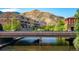 A view of a bridge over a river, with buildings on either side and a mountain in the background at 919 Russell St, Golden, CO 80401