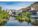 A view of the Coors Brewery complex along a river, surrounded by greenery and a mountain backdrop at 919 Russell St, Golden, CO 80401