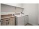 Well-lit laundry room with modern washer and dryer and storage cabinets at 919 Russell St, Golden, CO 80401