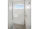 Modern walk-in shower with white tile, accent stripes, and glass door at 919 Russell St, Golden, CO 80401