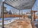 Backyard patio with a metal pergola, outdoor kitchen with grill, and a view of the fenced yard at 13517 Clayton Ct, Thornton, CO 80241