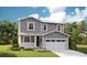 Charming two-story home with gray siding, stone accents, and an attached two-car garage at 6995 E 126Th Dr, Thornton, CO 80602