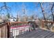 Wooden back deck with railing overlooks neighborhood at 69 W Cedar Ave, Denver, CO 80223