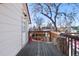 Side view of wooden back deck with railing at 69 W Cedar Ave, Denver, CO 80223