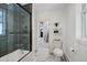 Bright bathroom with white marble floors, shower and tub featuring glass doors at 69 W Cedar Ave, Denver, CO 80223