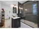 Bathroom featuring stylish vanity, mirrors and subway tile shower with glass door at 69 W Cedar Ave, Denver, CO 80223