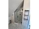 Modern bathroom featuring a walk-in shower with stylish tile work and sleek black fixtures at 69 W Cedar Ave, Denver, CO 80223