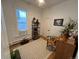 Cozy bedroom with an exposed window, shelving with decor and a vintage desk at 69 W Cedar Ave, Denver, CO 80223