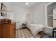 Bright bedroom with a twin bed, hardwood floors, and a vintage dresser at 69 W Cedar Ave, Denver, CO 80223